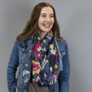 A grey scarf with a magenta, blue, yellow, white and grey flower pattern. Made from recycled polyester