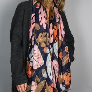 A large navy blue scarf with a leaf pattern in bold colours and sequin embellishments
