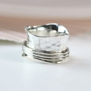 A sterling silver hammered textured wide ring with 3 wavy thin smooth silver spinning bands