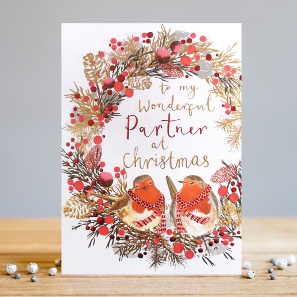 A lovely christmas card with an image of a wreath with two little robins and the words To my wonderful partner at christmas printed in the centre of the wreath.