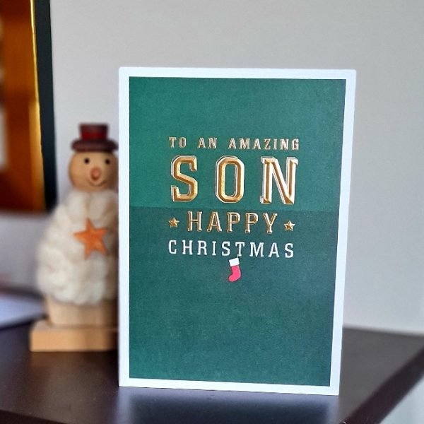 A green Christmas card with gold writing To an amazing son happy christmas