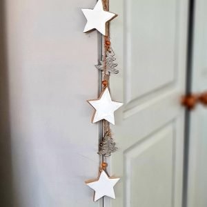 Stars and tree Christmas garland. Wish white enamel and wood stars and gold metal trees on a rustic rope twine to hang in your home at Christmas