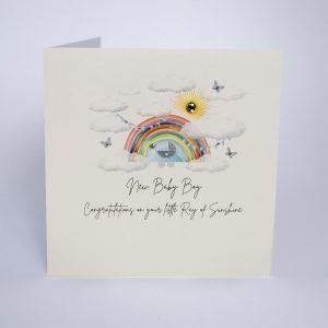 A gorgeous card from Five Dollar shake with an image of a rainbow and clouds with a pram and blue bunting on it. The words New Baby Boy Congratulations on your Little ray of Sunshine printed on it.