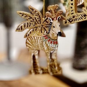 A wooden zebra decoration with a vintage print and a gold palm tree