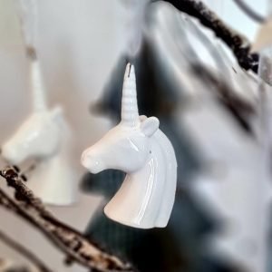 A white porcelain unicorn head with an organza hanging ribbon. An elegant Christmas decoration