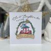 A cute christmas card from Tracey Russell with an image of a car with a christmas tree on top of it. The words Son and Daughter in Law are printed on the card and there is a wooden plaque that says With Love This Christmas etched into the wood.