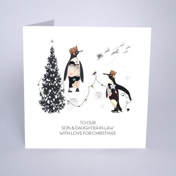 A lovely Son and Daughter in Law Christmas card With an image of two penguins that are decorating their Christmas tree. The words 'To Our Son and Daughter in Law with love for Christmas are printed on the card.