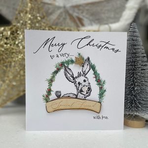 A gorgeous card with an image of a donkey on it and the words Mery Christmas to a special friend.