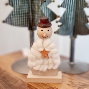 A wood and wool snowman with a top hat and a little wooden star