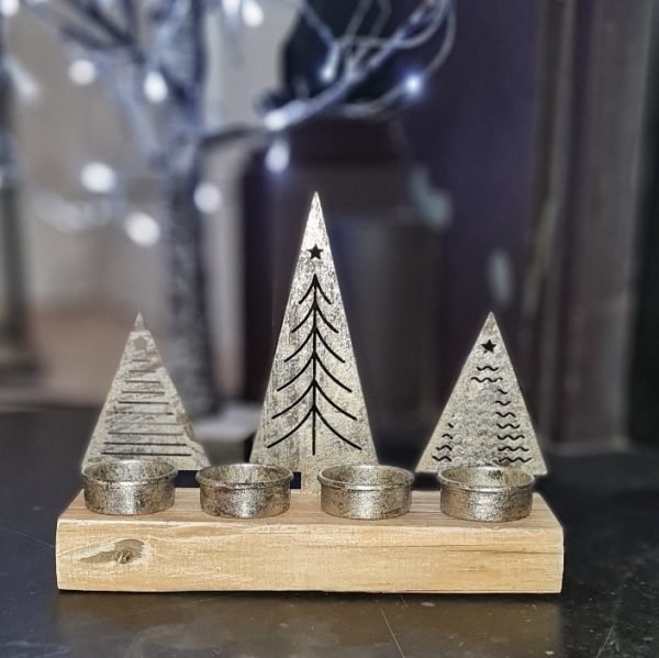Three metal Christmas trees set on a wooden base with t-light holders behind each tree
