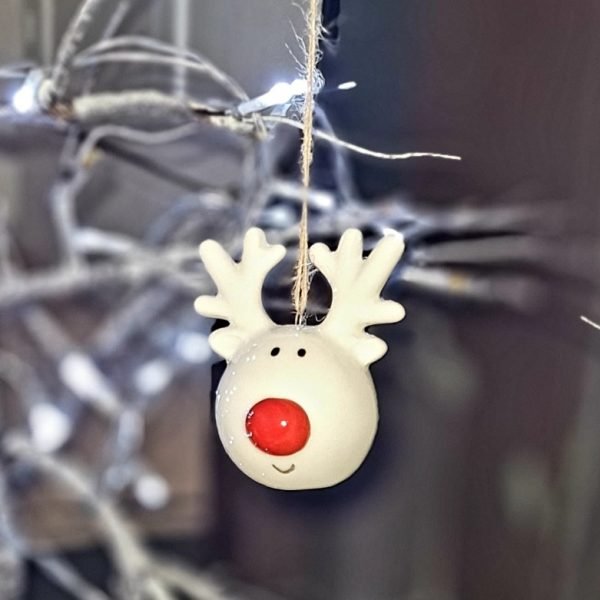 A white ceramic rudolf heat with a big red nose. A cute hanging decoration for the tree