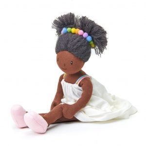 A gorgeous black rag doll with pretty white dress, pink shoes and beads in her hair.