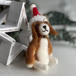 A cute felt dog wearing glasses and a christmas santa hat