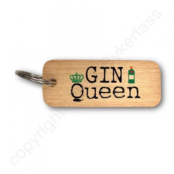 A wooden key ring with Gin Queen printed on it and a little crown on the Q and a bottle of gin