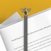 A metal bookmark with a black and gold bee