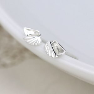 A pair of sterling silver stud earrings that are shaped like angel wings.