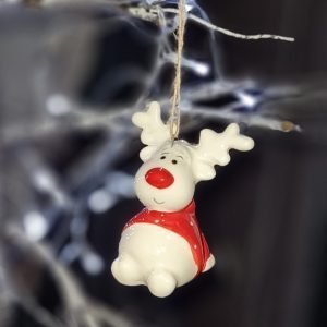 A cute ceramic sitting rudolf hanging decoration. White ceramic Rudolf with a red nose and a red and white spotted jumper