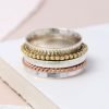 A lovely sterling silver ring with additional rose gold and gold plated spinning rings on it