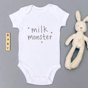 A white baby vest with milk monster printed on the front in white