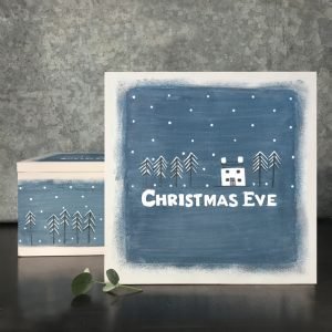 A lovely wooden box with a blue theme and the words Christmas Eve written on it and a Christmas house theme.