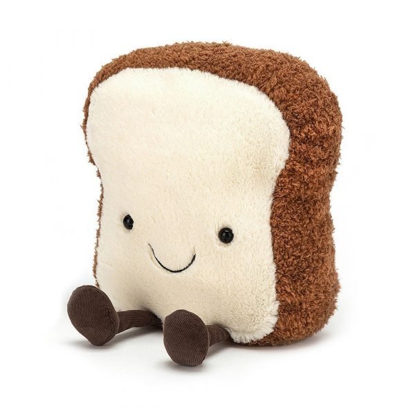 A cuddly toy made to look like a slice of toast with a happy smiley face and with chocolate coloured legs and feet.