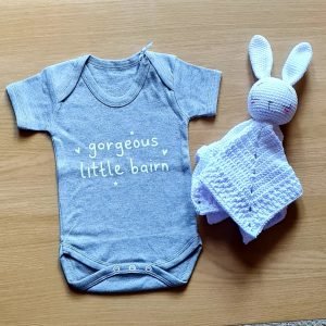 A grey baby vest printed in white with gorgeous little bairn.