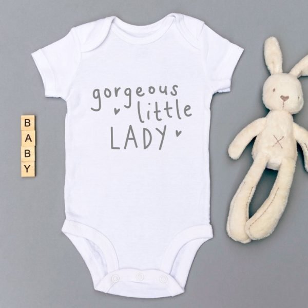 A white cotton baby vest printed in grey with gorgeous little lady. Fits size new born to 3 months