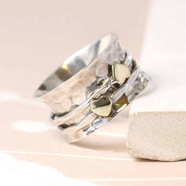 Sterling silver textured wide band ring with two small brass hearts on fine spinning bands