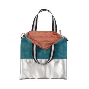 A teal velvet and silver faux leather cross over hand bag. The teal velvet is printed with a chameleon design. The strap is detachable and the lining is peach sateen.