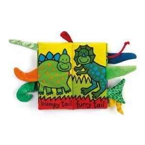 Jellycat soft book about dinosaurs with dinosaur tails that have different textures that protrude from the book