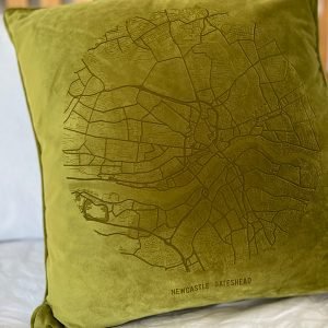 A fabulous bamboo green coloured velvet cushion with a map of Newcastle and Gateshead imprinted on it.