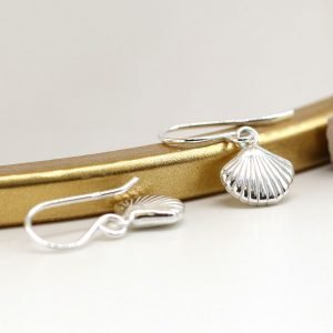 A pair of sterling silver drop earrings with a clam shell design