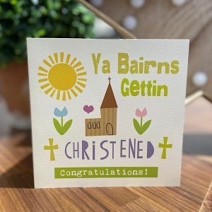 A geordie Christening card with an image of a church and flowers and Ya Bairns gettin Christened printed on the front