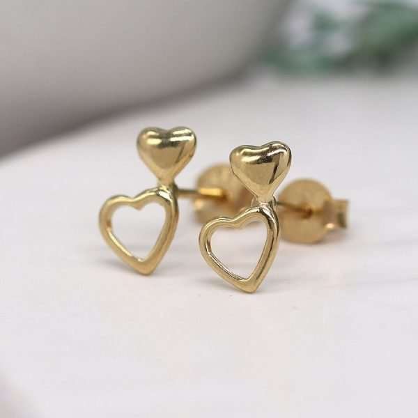 A pair of gold plated double heart stud earrings