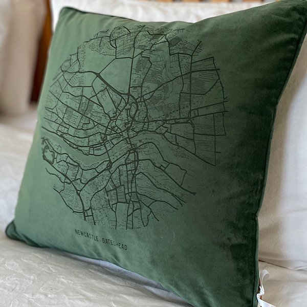 A fabulous Bottle Green coloured velvet cushion with a map of Newcastle and Gateshead imprinted on it.