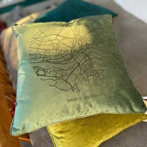 A fabulous Bottle Green coloured velvet cushion with a map of Newcastle and Gateshead imprinted on it.