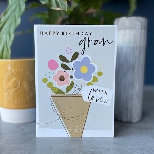 A card with an image of a bunch of flowers and the words Happy Birthday Gran printed on it.