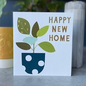 A Happy New Home card with an image of a pot plant with a blue and white spotty pot on it.