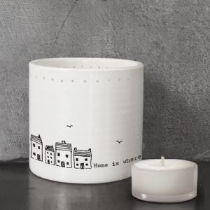 A gorgeous tea light holder with an image of little houses and the words Home is Where the heart is written on it.