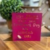 A deep red card with gold foil writing that says Yoga Drama - When your downward dog has Spaniels ears!