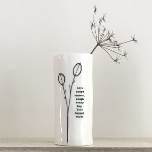 A lovely porcelain vase with an image of a flower bud and the words Live Every moment laugh every day love beyond words on it.
