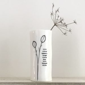 A lovely porcelain vase with an image of a flower bud and the words Live Every moment laugh every day love beyond words on it.