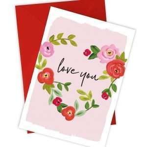 A wonderful Valentine's card with a heart made up of flowers and leaves with the words Love You printed in the middle of the heart.