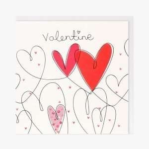 A lovely card with a looped heart design with one red heart, one pink and one spotty heart. The word Valentine is printed above the hearts.