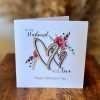 Husband With Love Valentin'es Day Card. A floral design with two wooden cut out hearts