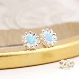 A beautiful pair of sterling silver flower stud earrings with a blue opal centre