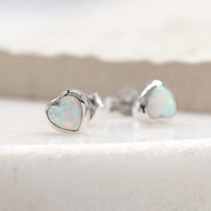 A stunning pair of sterling silver heart stud earrings with white opal centre.