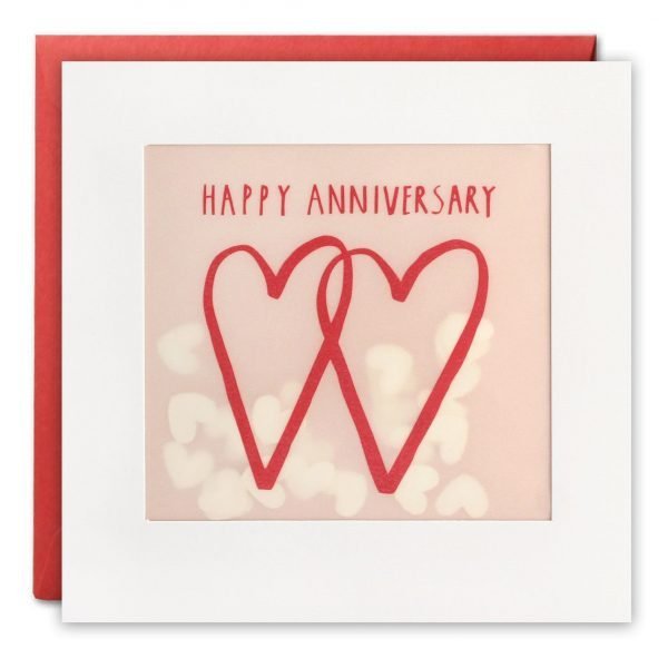 An anniversary card with an image of two hand drawn interlinked red hearts. The words 'Happy Anniversary' are written in red at the top of the design. The image is printed on translucent paper, showing coloured confetti hearts behind. The confetti moves around when you shake the card. The card is white