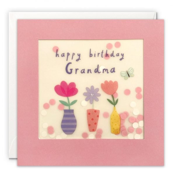 A Grandma birthday card featuring an image of 3 vases of flowers. The message on the front reads 'Happy Birthday Grandma'. The image is printed on translucent paper, showing cream paper confetti dots behind. The confetti moves around when you shake the card. The card is pink