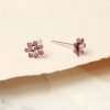 A pair of pink mini flower studs with crystal inset in the centre